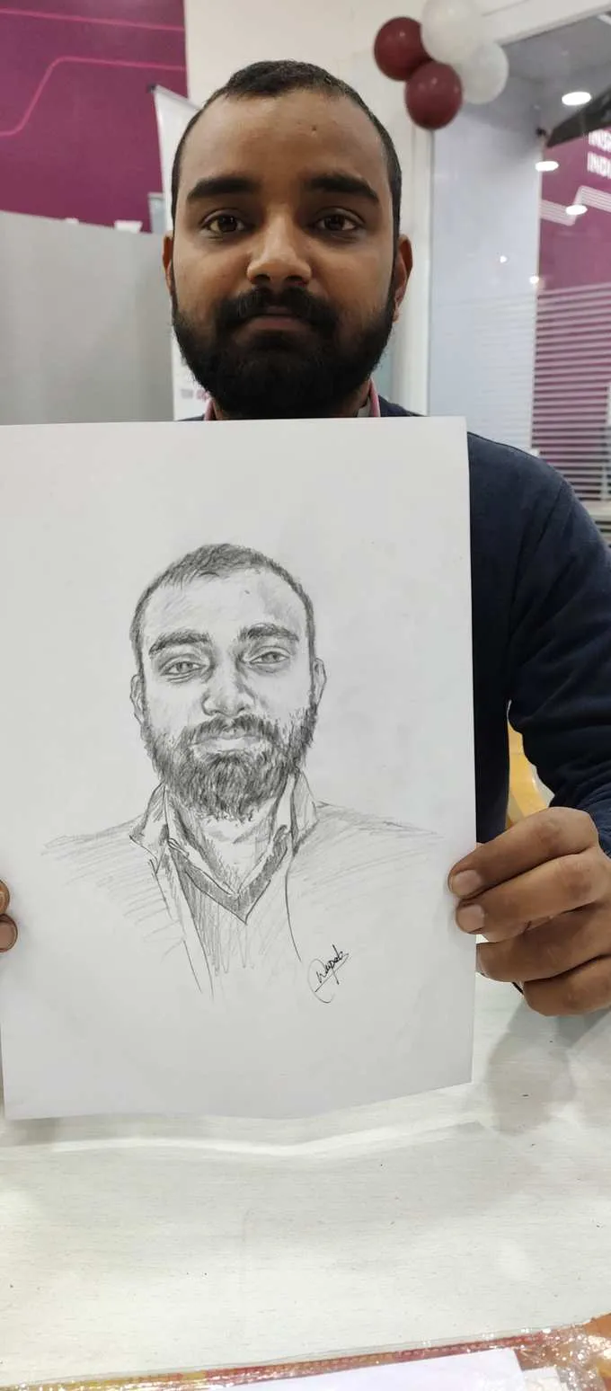 Customer holding their finished pencil sketch portrait